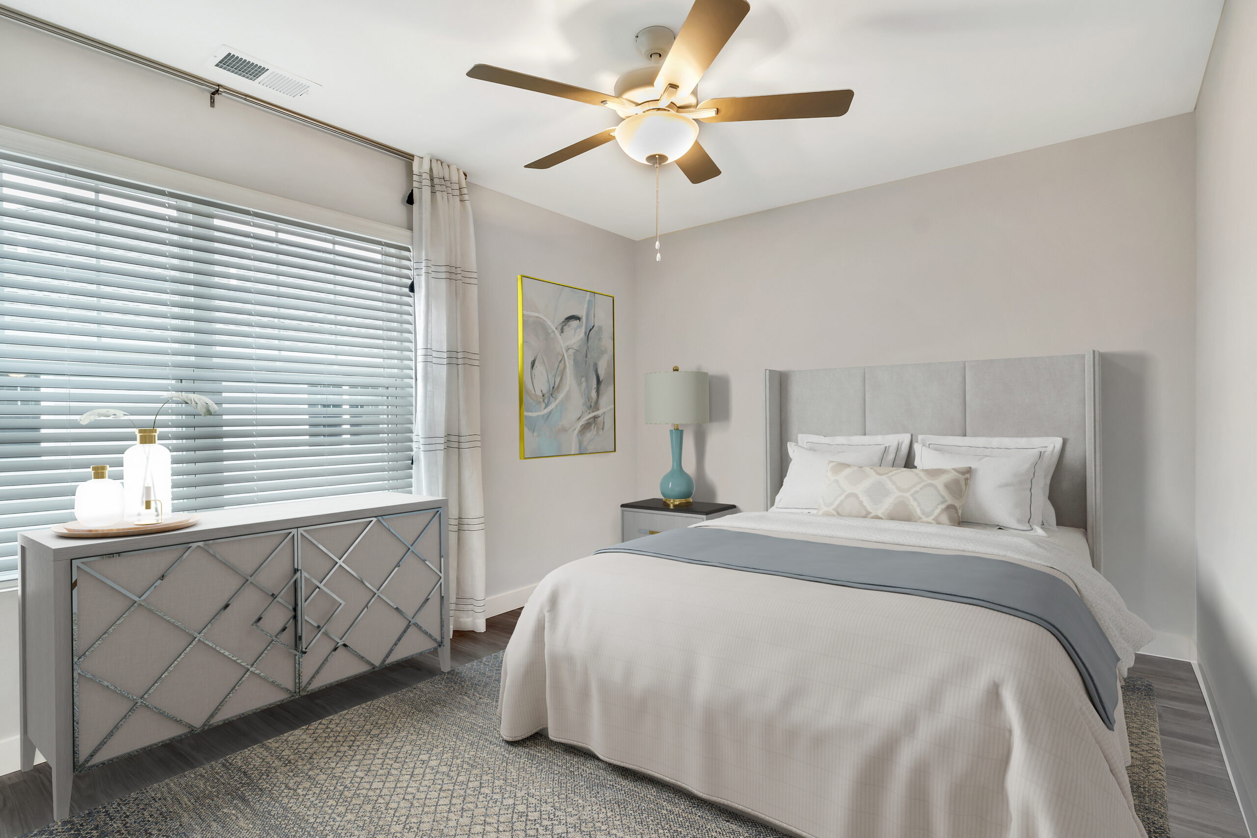 Bedroom with a king bed, ceiling fan and a mirrored dresser at Willow Glen Apartments